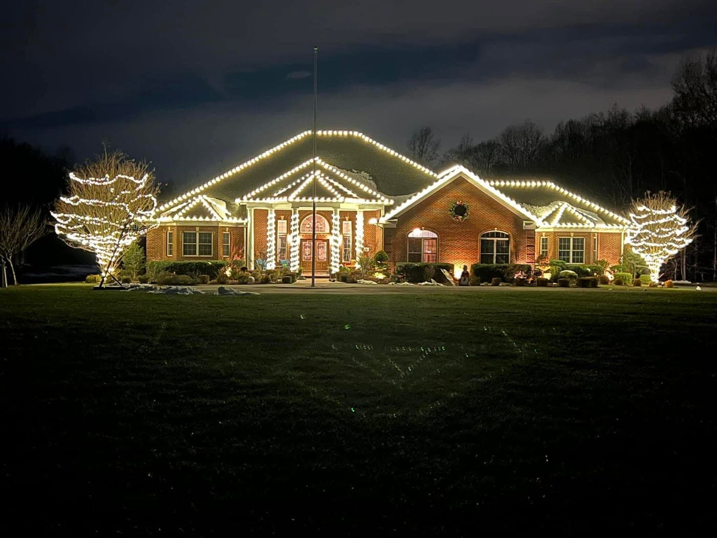 Professional warm-white Christmas light installation on a brick home in Southern Maryland